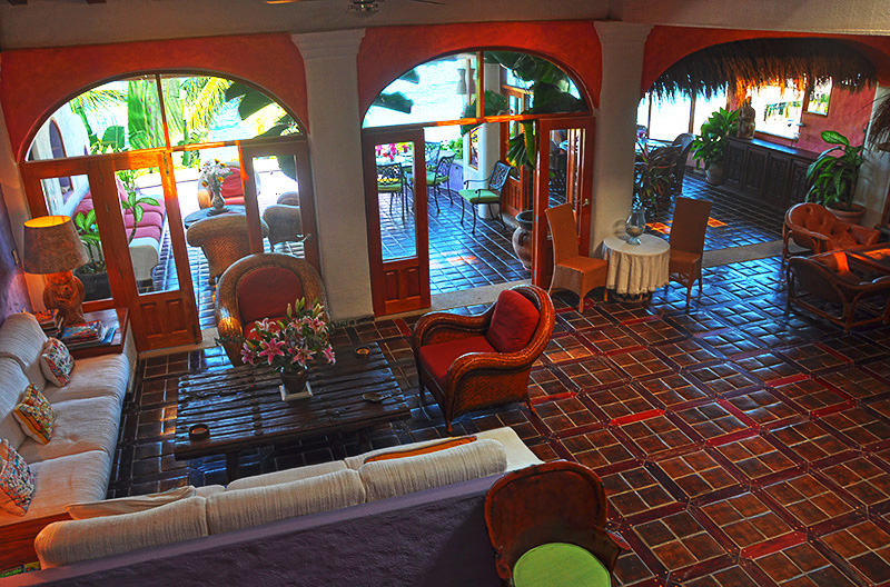 The wondrous 40' living room with ceiling 18 feet high, open and wide to take advantage of the gentle Pacific breezes.  Underfoot, the floors are hand-crafted tiles set into surrounds of iron wood.